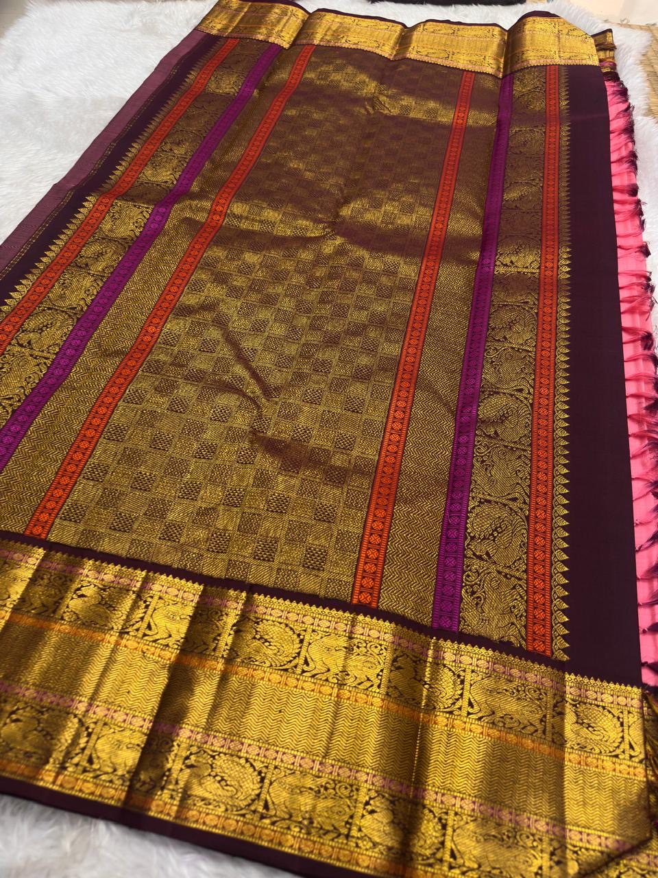 Deep plum Yazhi border pallu in gold zari on radiant pink Kanjeevaram saree