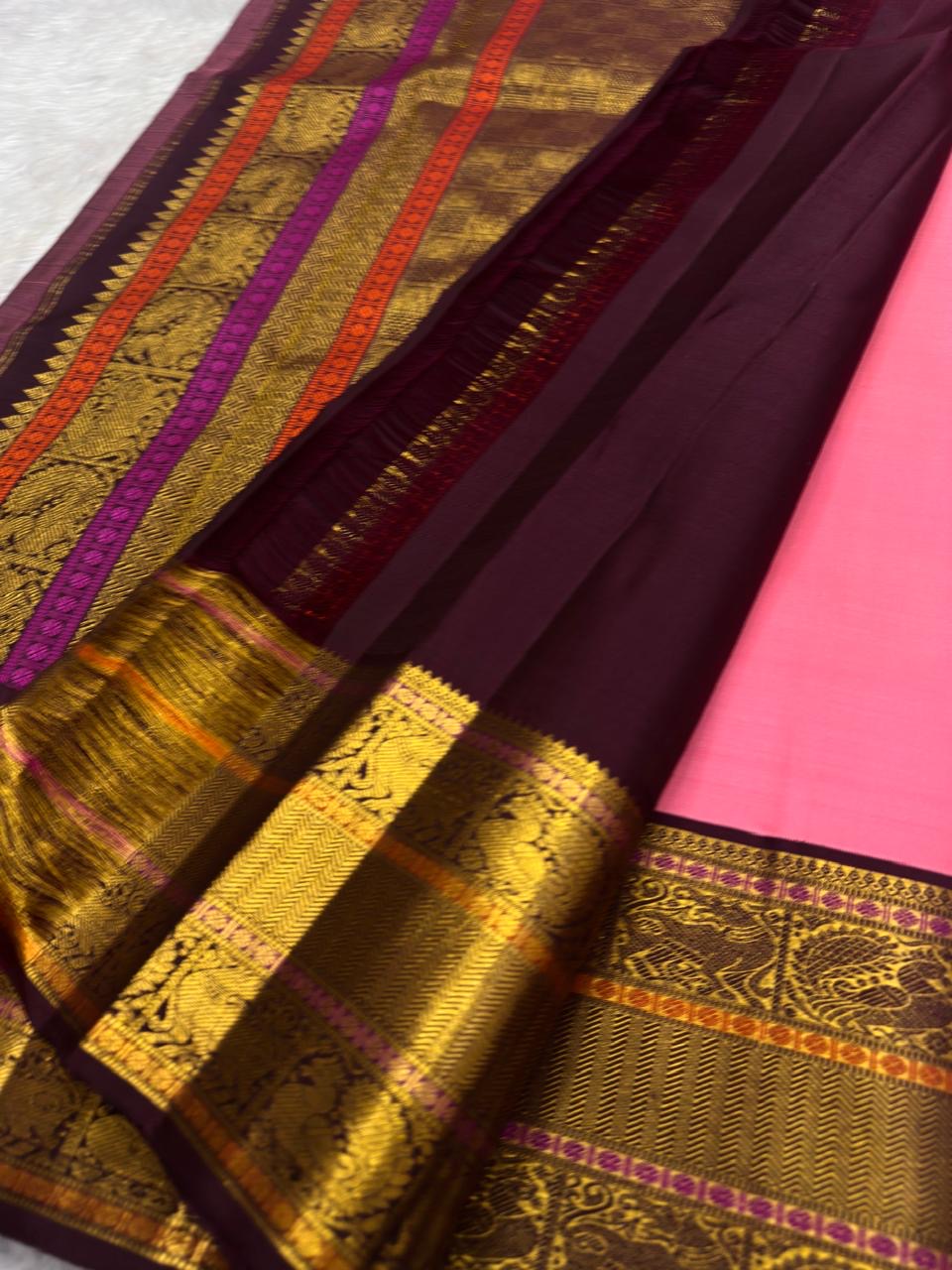 Folded view of radiant pink pure silk Kanjeevaram saree with Varisaipet Yazhi border
