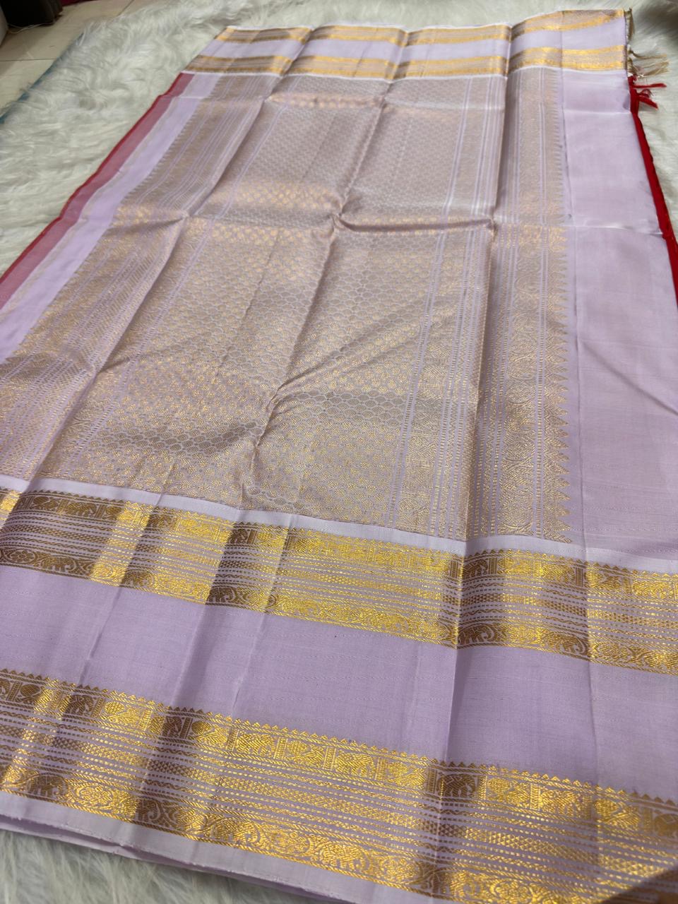 Radiant red Kanjeevaram silk saree with pale lavender Rettapet border, full view