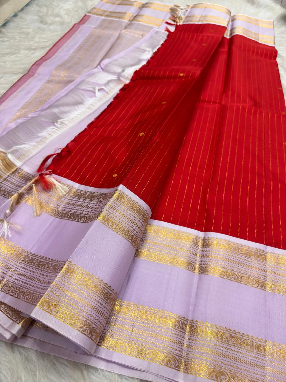 Radiant red Kanjeevaram silk saree with pale lavender and gold zari pallu