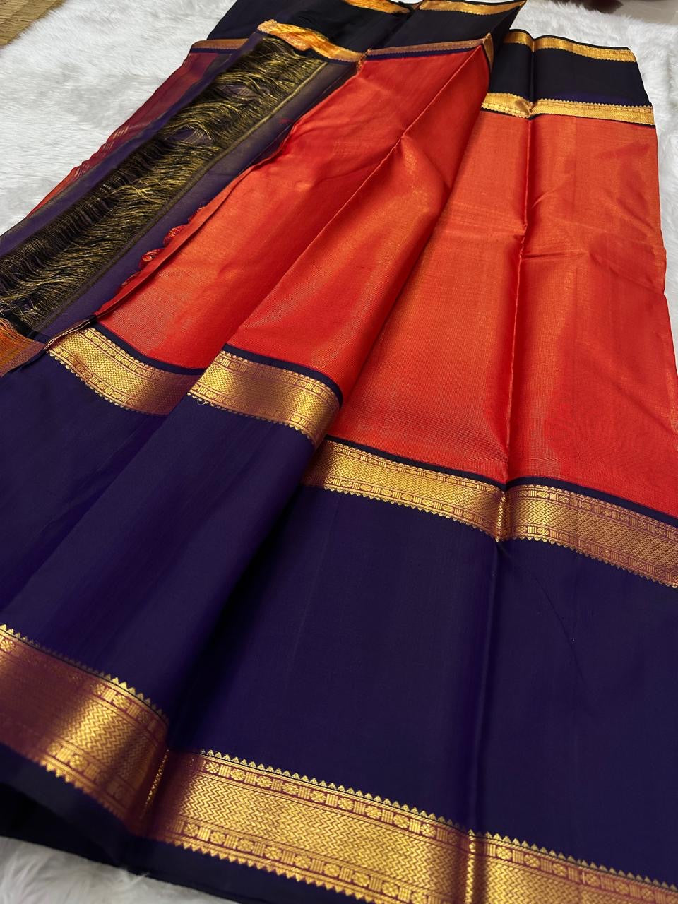 Handwoven orange Kanchipuram silk saree with finely interwoven antique gold zari