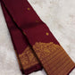 Gold zari border on Arakku red and coffee brown shot-colour Kanjivaram saree