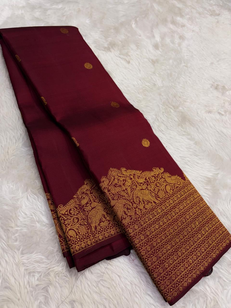 Gold zari border on Arakku red and coffee brown shot-colour Kanjivaram saree