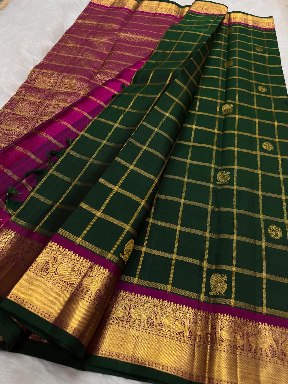 Rani-Magenta Kanchipuram border with broad antique-gold zari and repeated peacock imagery — Idam Living