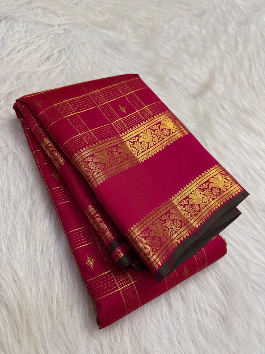 Fine antique-gold Zari Kattam checks woven across the luminous Rani Magenta Kanjivaram silk body.