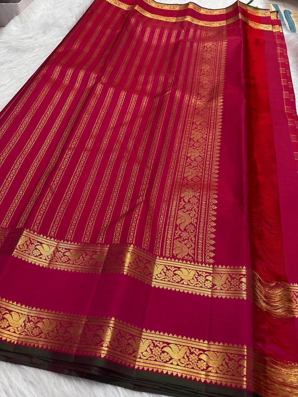Tiny individual gold zari buttas positioned within the checked Rani Magenta pure silk body.