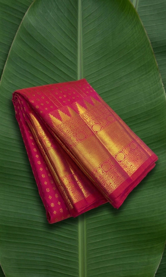 Kanchipuram silk saree in rani pink with antique gold border Kamalam Butta weave folded view