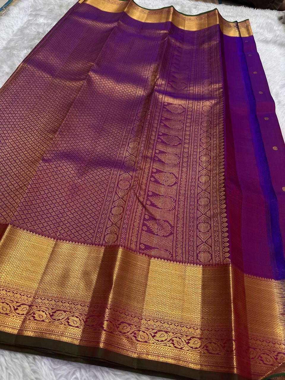 Pink pure silk Kanjivaram Butta saree with broad antique-gold zari border.