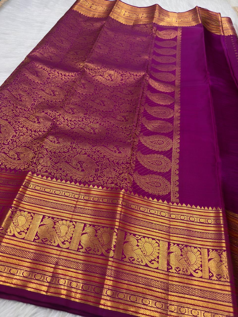 Rani Pink pure silk Kanjeevaram Butta saree with dense gold zari buttas and Mayil border.