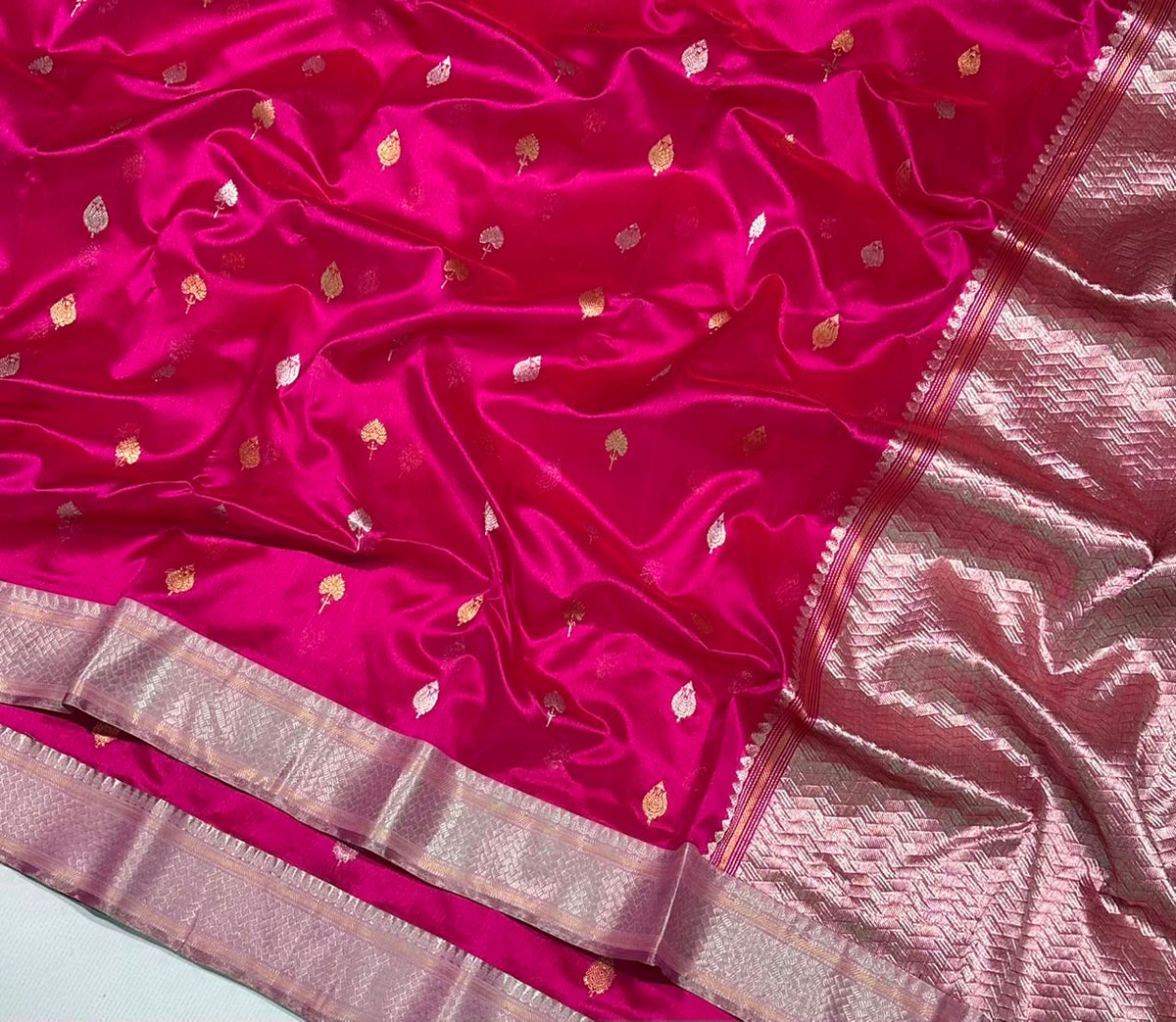 Rani Pink Pattu Silk Chanderi saree showing the broad woven metallic border.