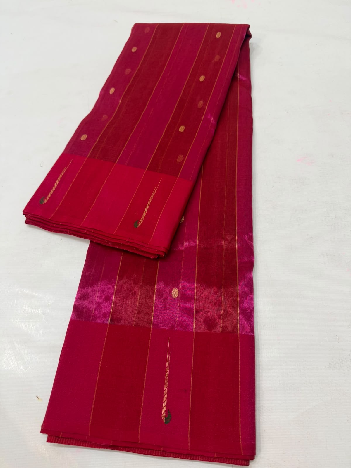 Rani Pink Tissue Silk Chanderi saree border showing the Muniya-style painted detail against the fine jari weaving
