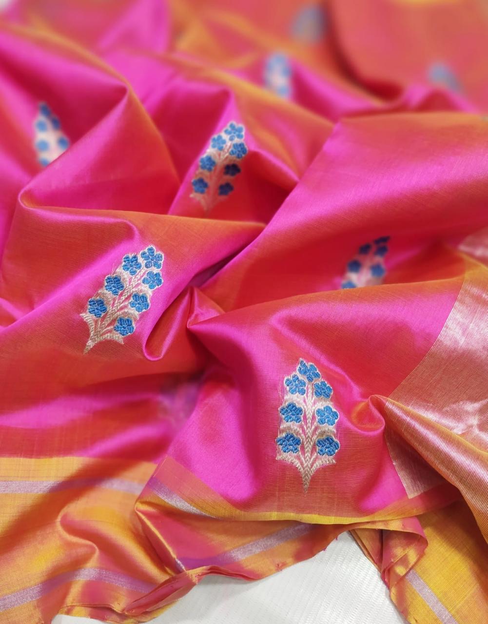 Rani pink Pattu Silk Chanderi saree showing blue floral sprig motifs