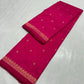 Close-up of gold-toned floral accents on rani-pink silk