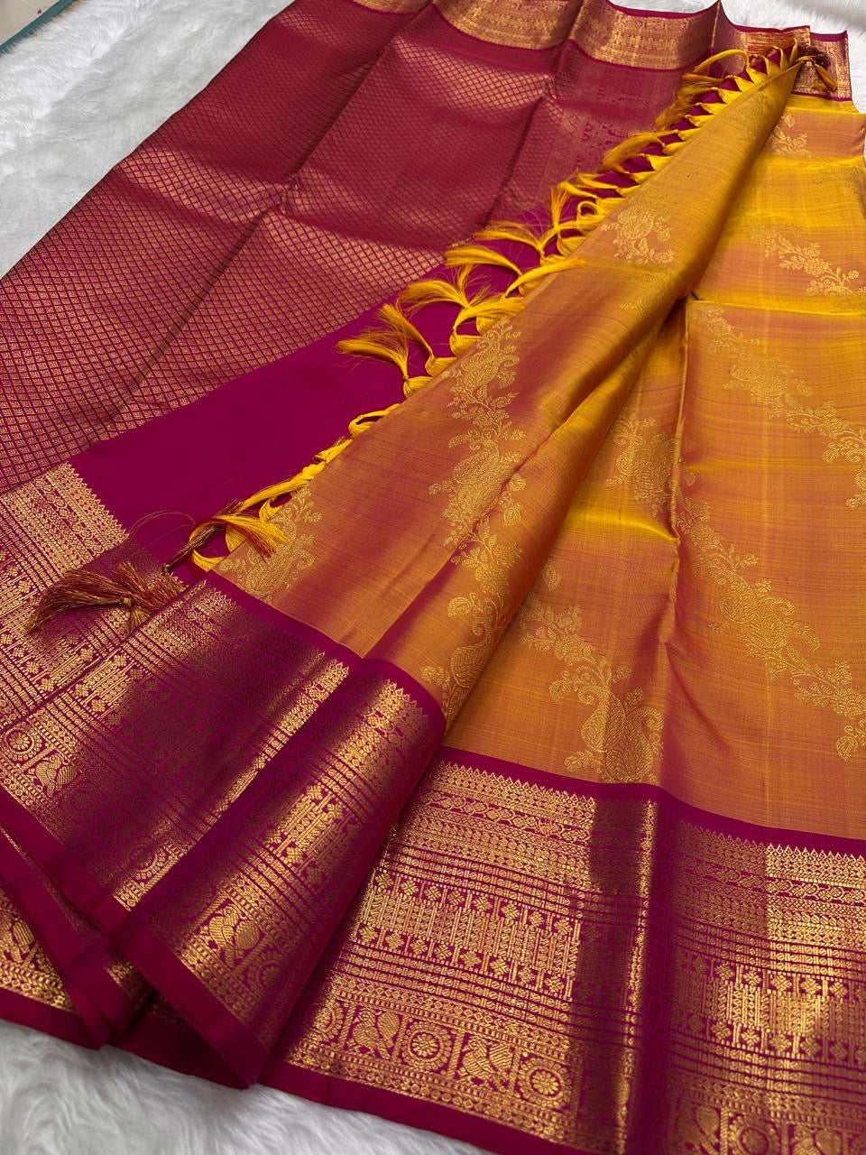Rani Pink border with classic-gold zari on the Sampangi Gold Kanchipuram saree.