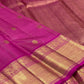 Dense gold zari pallu with repeating geometric field on saturated Rani Pink silk.