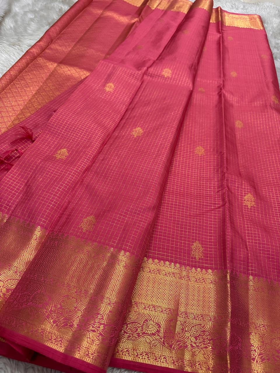 Close view of fine antique-gold checked Zari Kattam woven across Rani Pink pure silk.