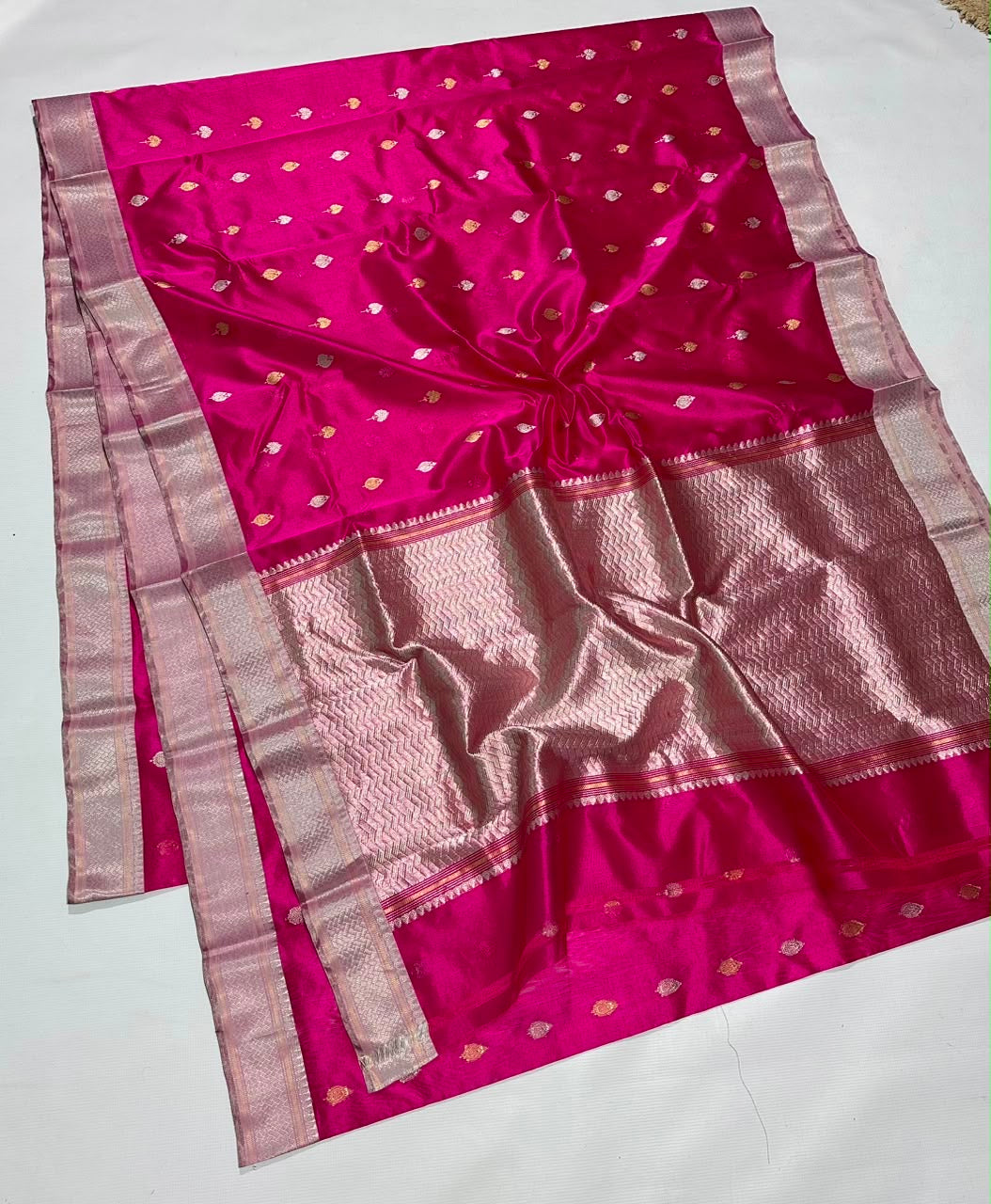 Rani Pink Pattu Silk Chanderi saree detail with gold leaf-shaped buttas catching the light.