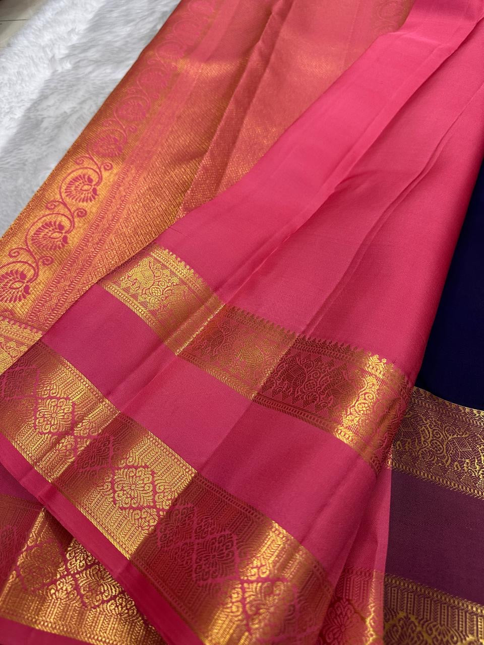 Rani Pink Kanchipuram border with broad floral gold zari, geometric separators and fine Reku-style bands.