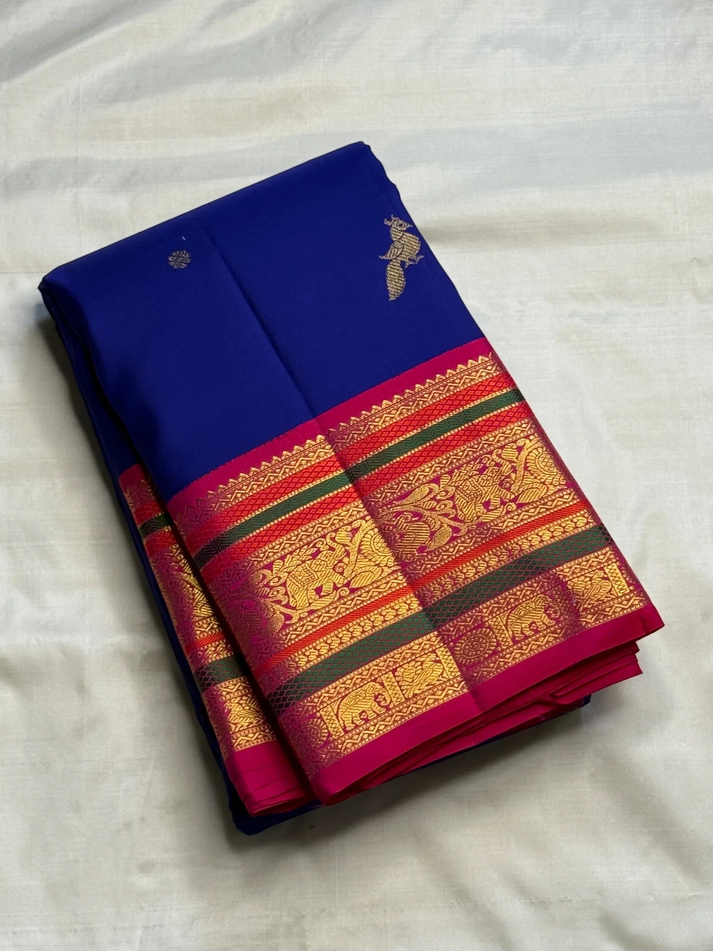 Rani Pink Kanchipuram pallu densely woven with gold zari geometric, bird and ornamental registers.