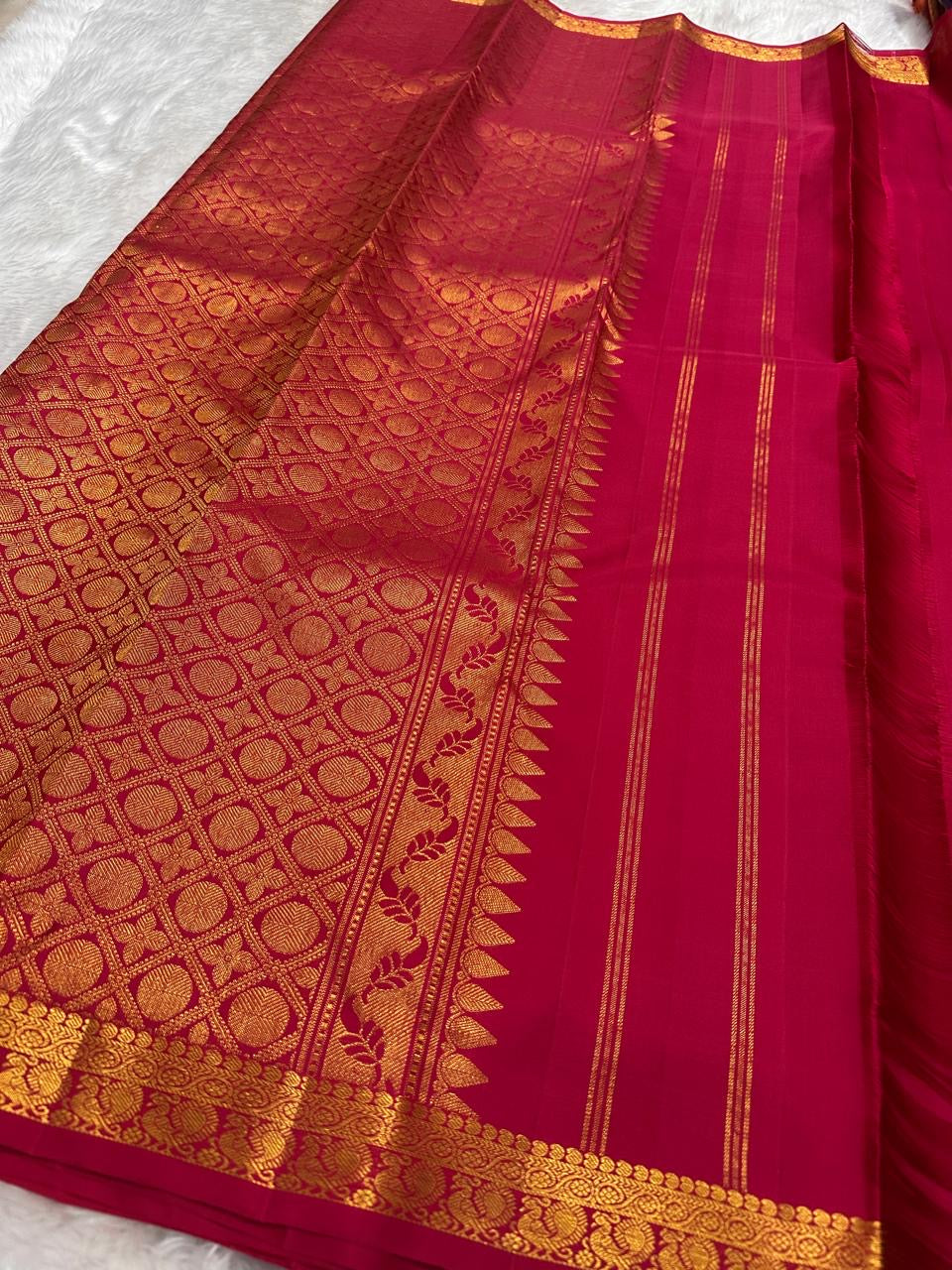 Saturated Sindoor Red silk body showing individually spaced small classic-gold zari buttas.