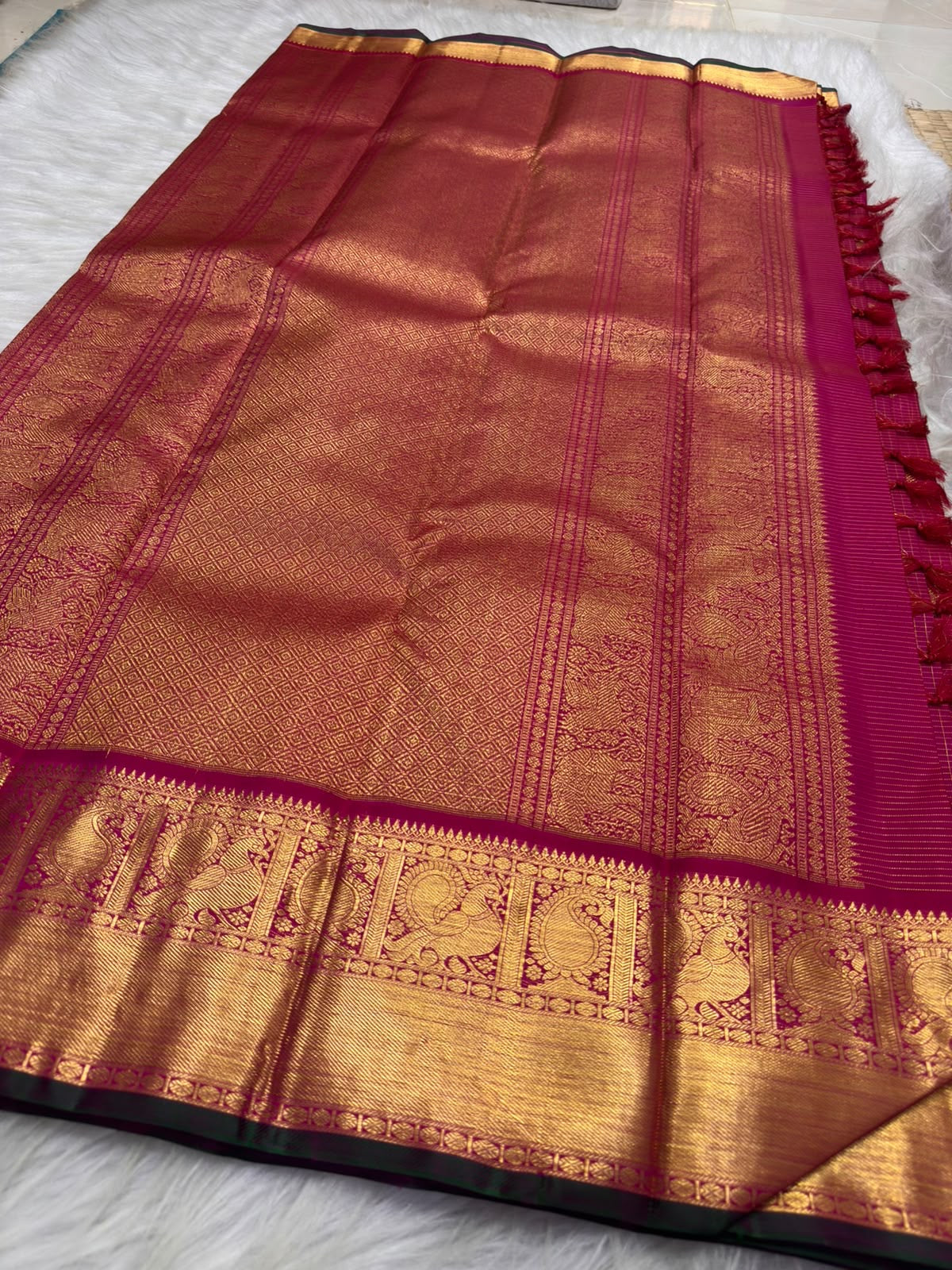 Rani Pink Pure Silk Kanchipuram with fine gold Zari Kattam, Chakram buttas and broad Maanga zari border.