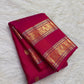 Gold-zari buttas spaced across saturated Rani Pink Kanchipuram silk.