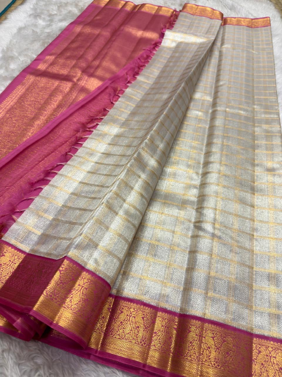 Rani Pink Korvai border with rich gold zari on Ivory Kora silk.