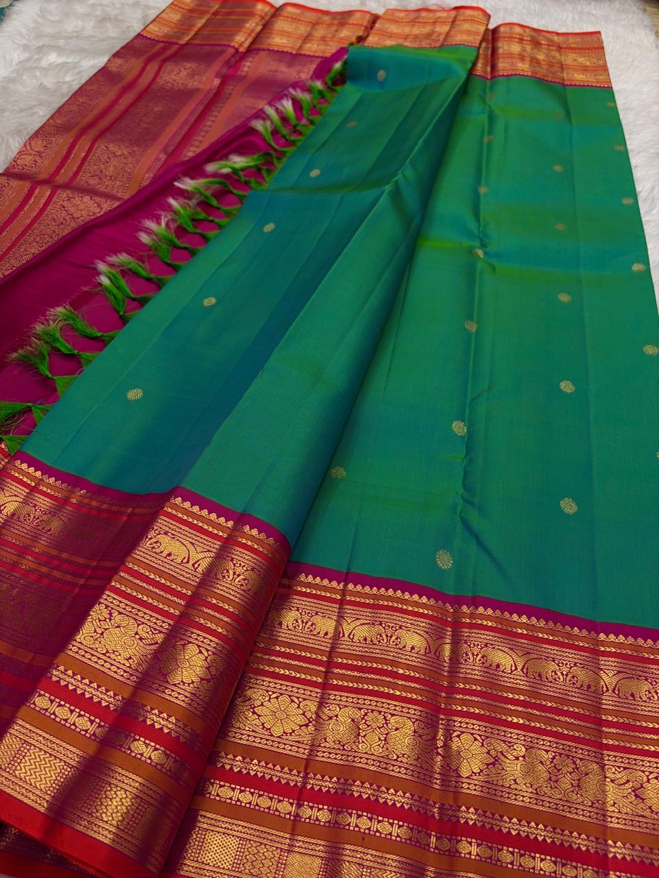 Kanchipattu silk saree in peacock teal with rani pink border Korvai Varisaipet weave traditional zari detail
