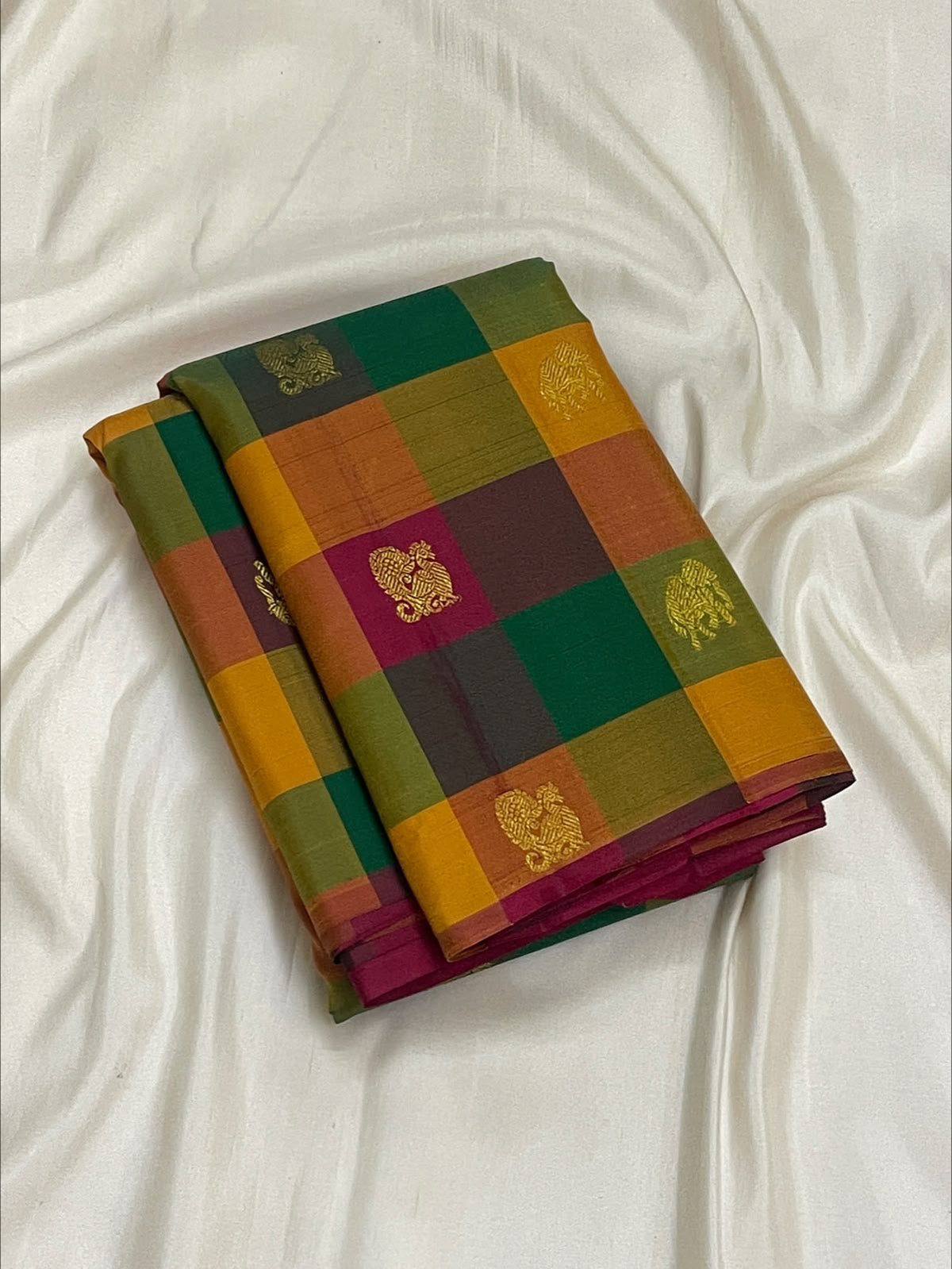 Laid-out multicolour Paalum Pazhamum Kanchipuram saree showing vibrant checks and a rich pink pallu.