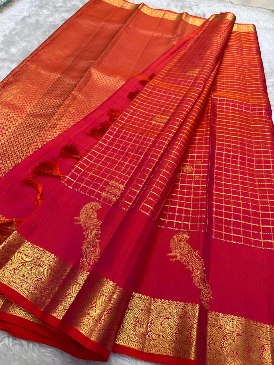 Traditional Mayil peacock border in antique gold on Chilli Reddish Pink Kanjivaram saree.