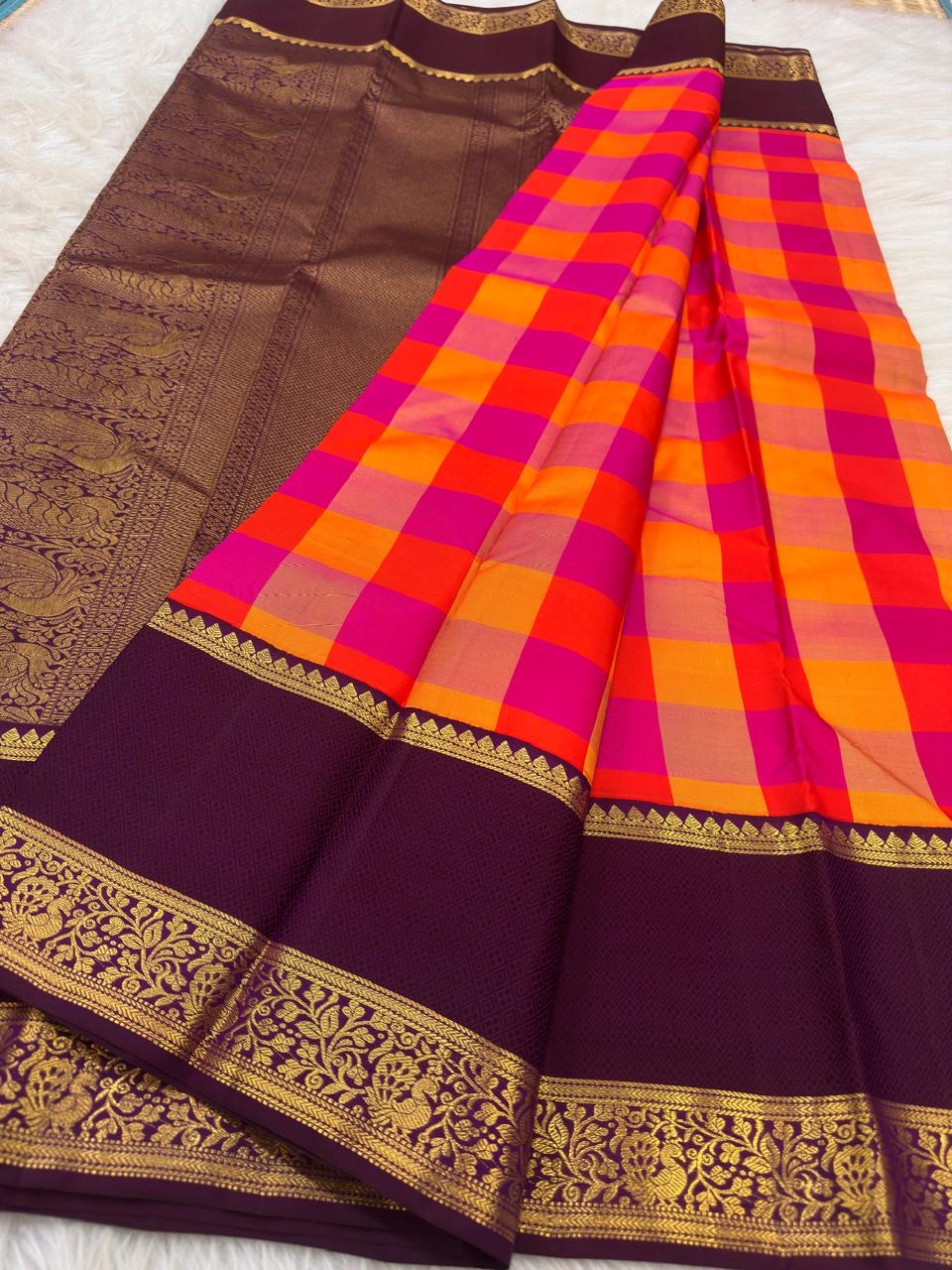 Orange and Rani pink Paalum Pazhamum Pure Silk Kanchipuram saree with traditional checks.