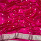 Rani Pink handloom Pattu Silk Chanderi saree folded to show scattered gold leaf buttas and broad metallic border.