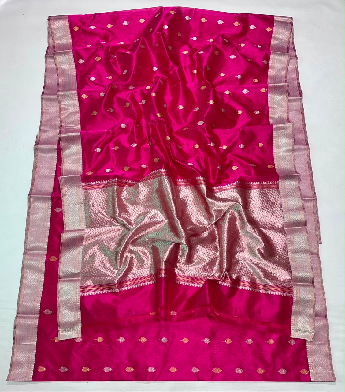 Rani Pink Pattu Silk Chanderi saree displayed in full length showing the saturated pink body and metallic detailing.