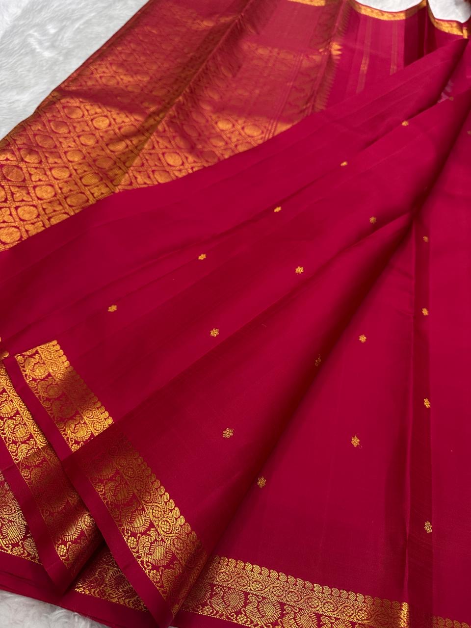 Tonal deep-red Kancheepuram border with repeated bird-and-floral classic-gold zari ornament.