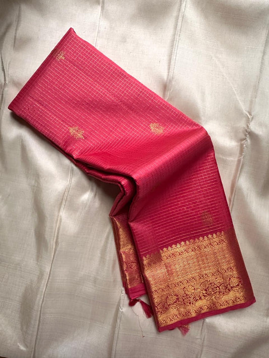 Rani Pink Kanchipuram silk saree with intersecting gold Zari Kattam lines and spaced traditional buttas.