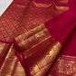 Handwoven sindoor red Kanchipuram silk saree with traditional gold zari buttas.