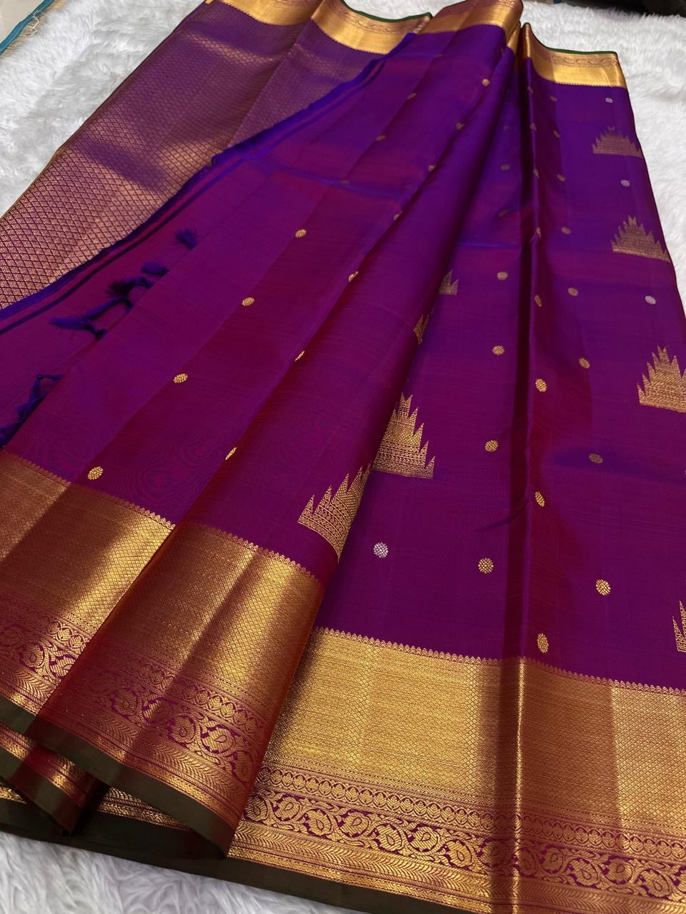Handwoven Rani Pink Kanchipuram silk saree with antique-gold zari and Deep Green selvedge.
