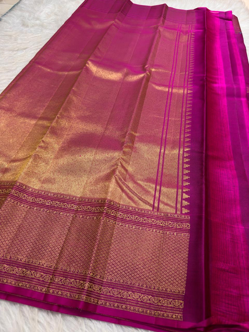Jewel-toned Rani Pink pure silk saree with intricate handwoven floral zari coloration.
