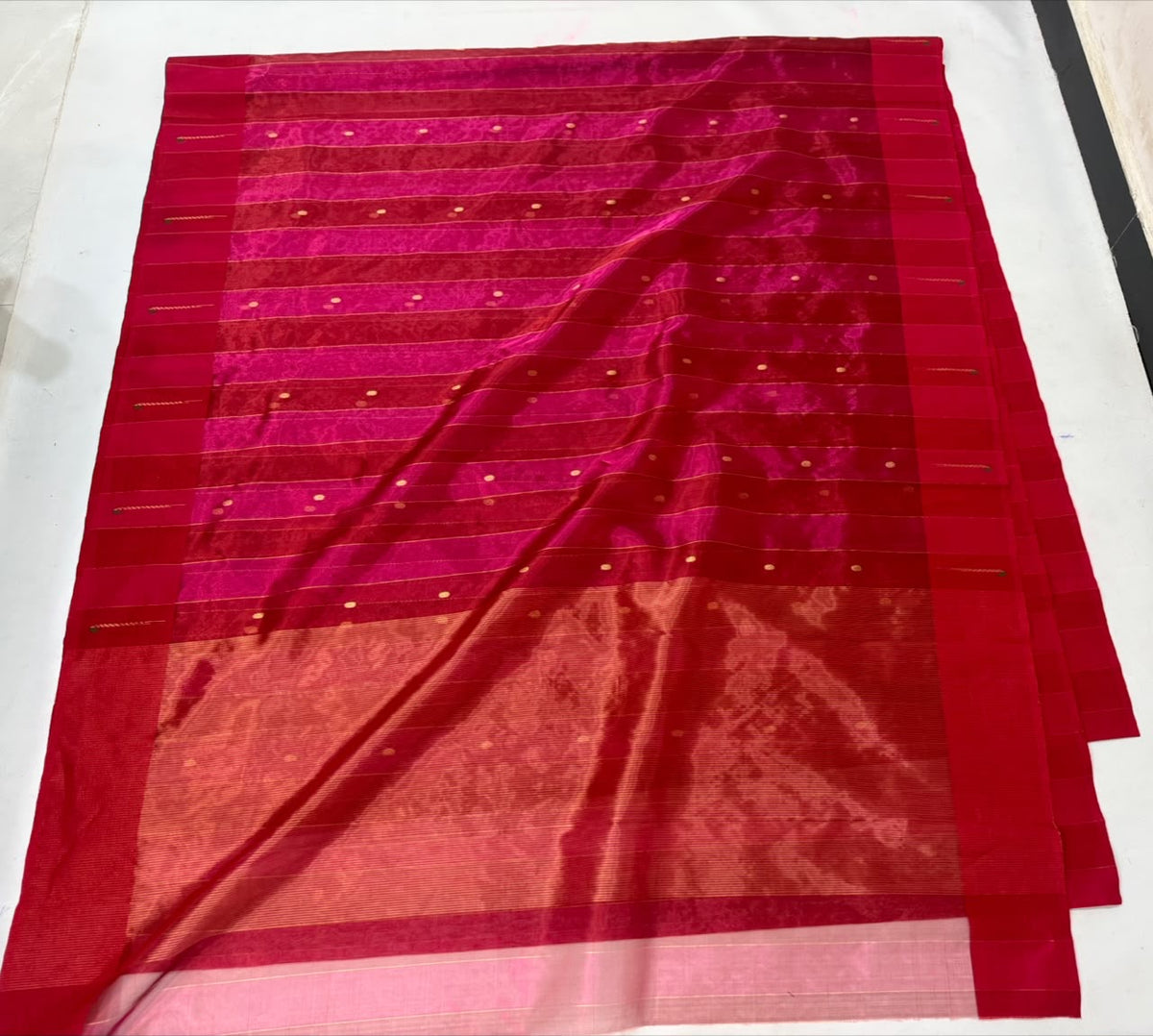 Rani Pink Tissue Silk Chanderi saree displayed with fine jari stripes, gold buttas and Muniya-style painted border details
