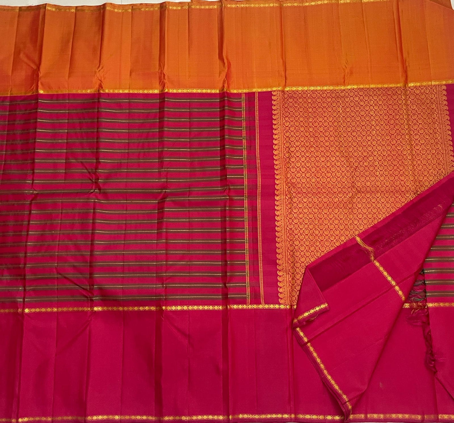 Chilli Red Rettapet Kanchipuram saree showing Veldhari zari and silk-thread stripes with contrasting Burnt Orange border.