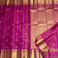 Compact ornamental gold zari butta against the luminous Rani Pink silk surface.