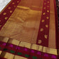 Close detail of Rani Pink Yaanai and saturated green bird-inspired motifs against classic gold zari.