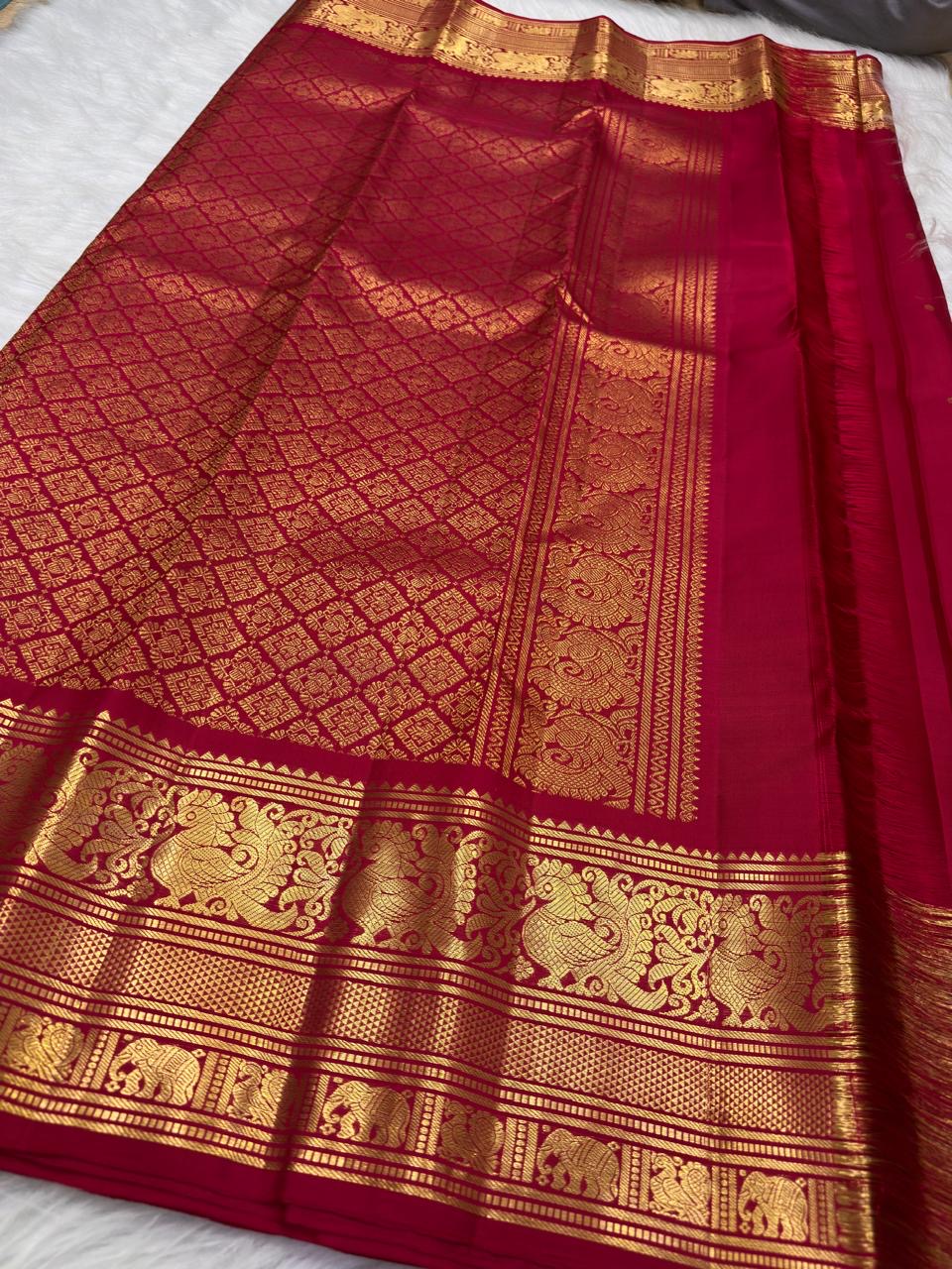 Sindoor Red pure silk Kanjivaram Butta saree with ornate antique-gold Yazhi border.