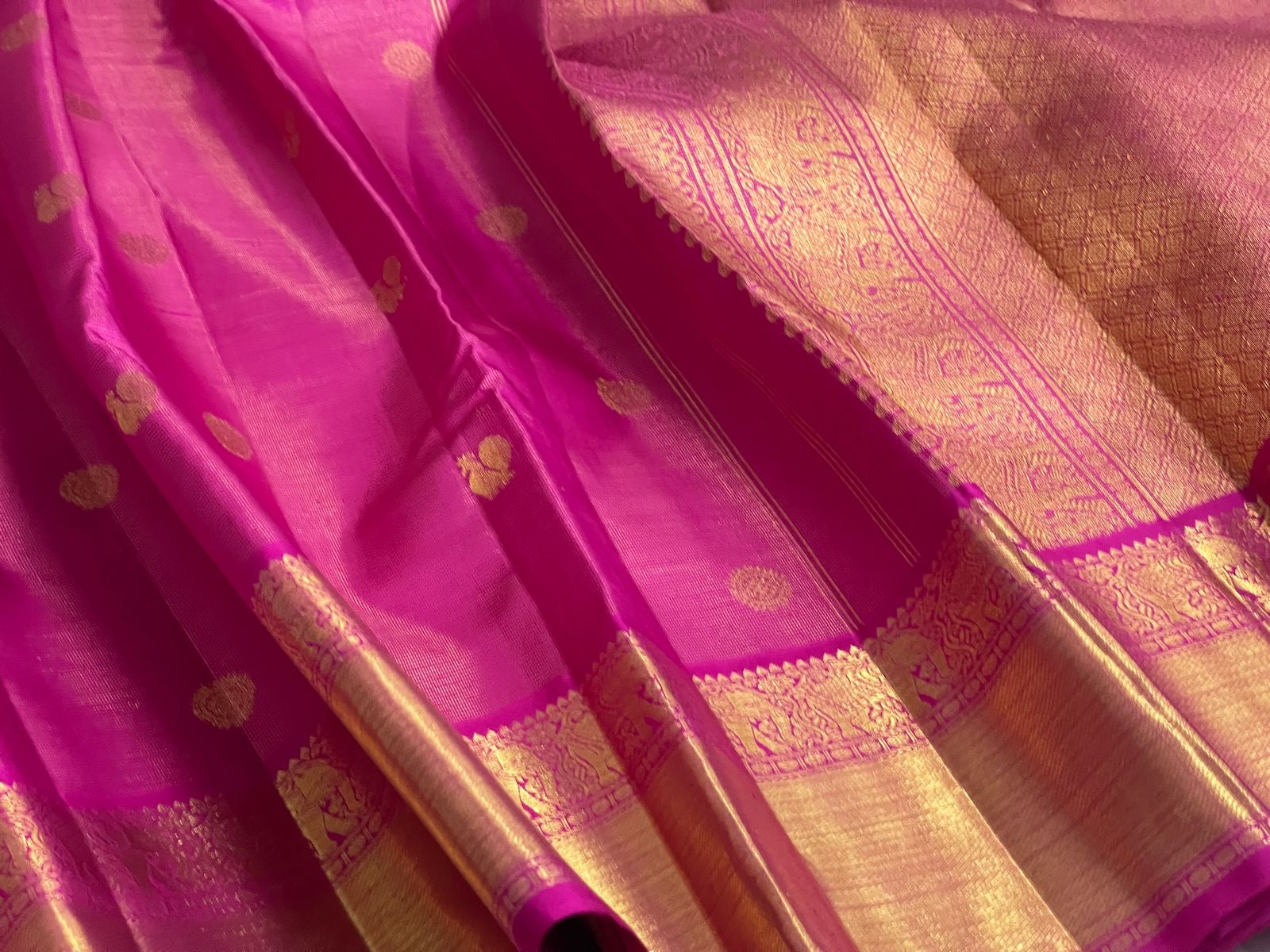Full Rani Pink Zari Kattam saree showing gold buttas, broad zari border and rich pallu.