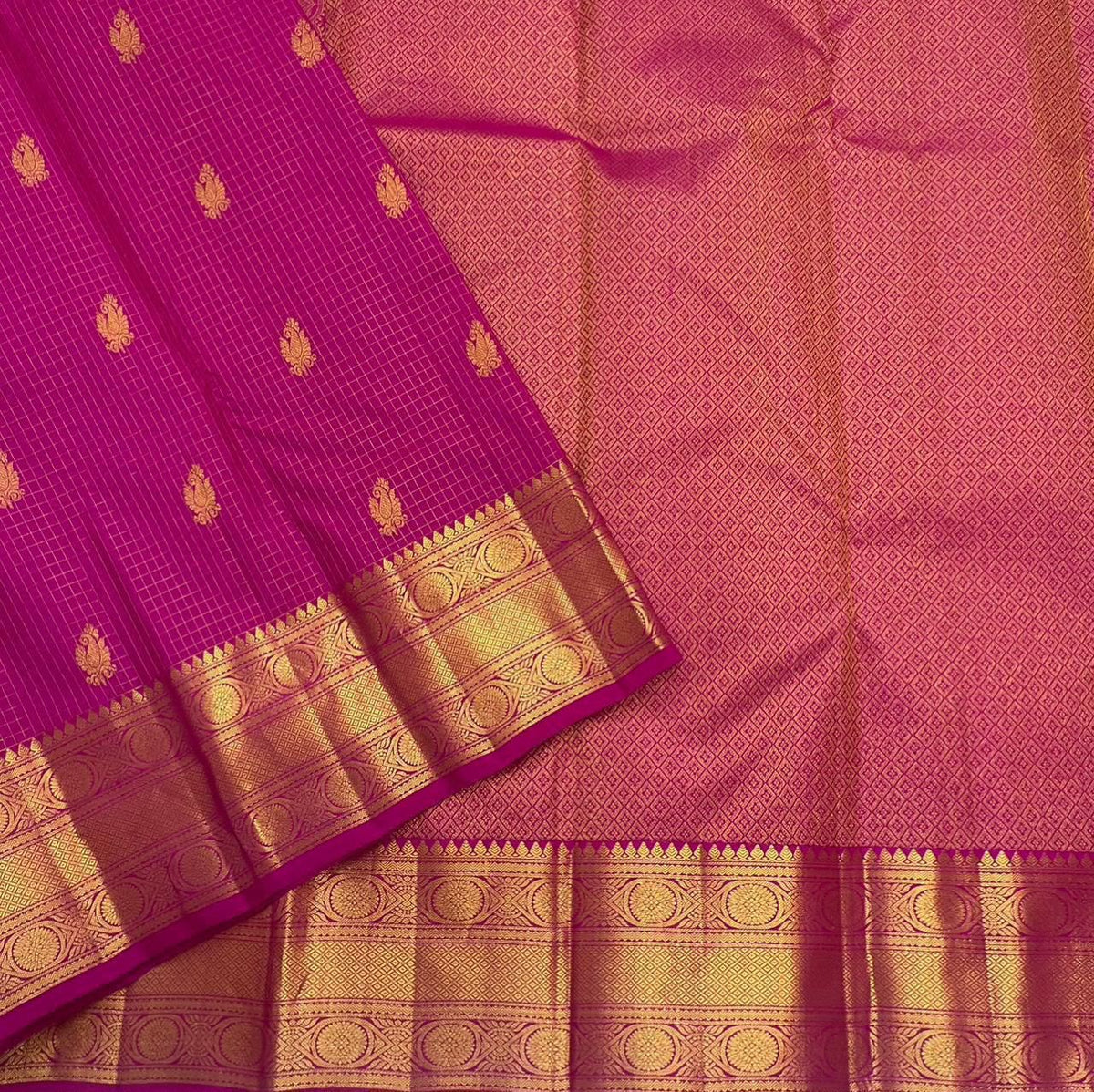 Full view of the Rani pink handwoven Pure Silk Zari Kattam saree with gold medallion border
