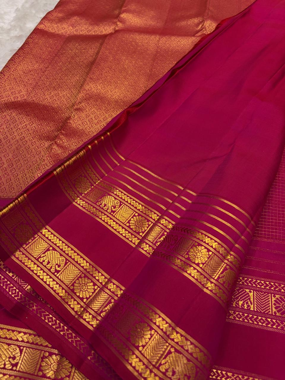Antique-gold zari medallion butta woven across Pomegranate Pink Kanjivaram silk.