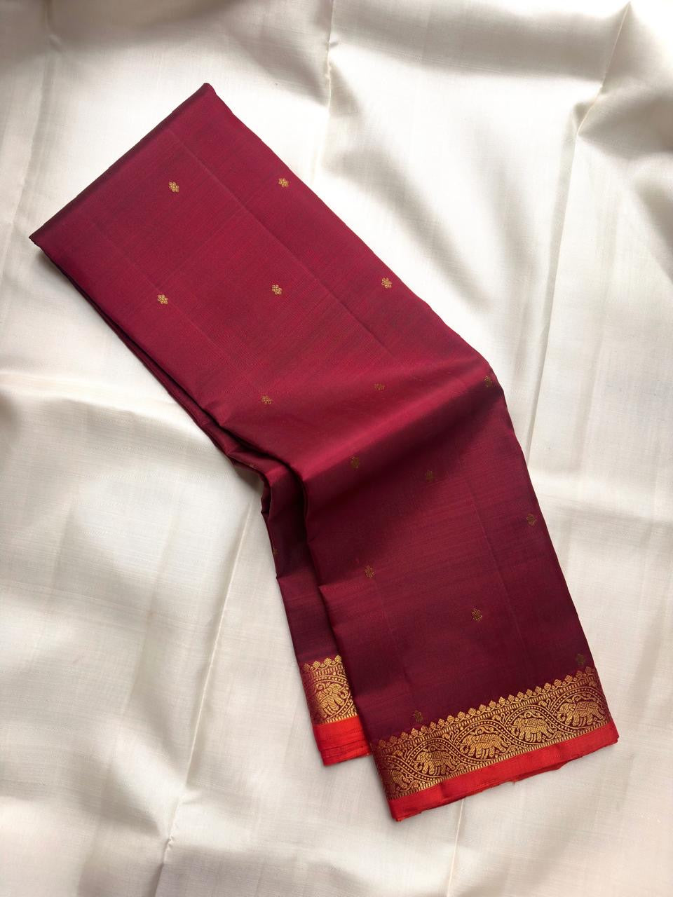 Deep Raspberry Maroon pure silk Kanchipuram saree with traditional elephant motif border.