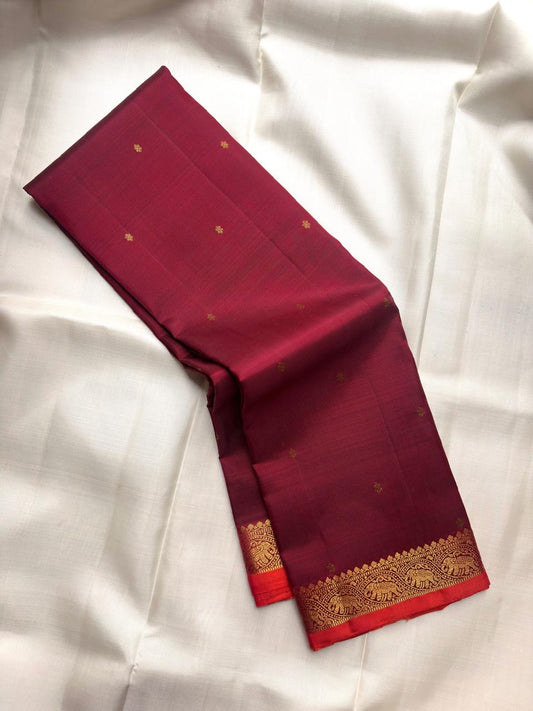 Deep Raspberry Maroon pure silk Kanchipuram saree with traditional elephant motif border.