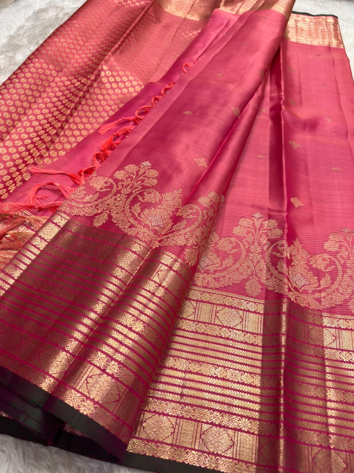 Handwoven pink Kanjivaram Vairaoosi saree with intricate stacked gold zari border