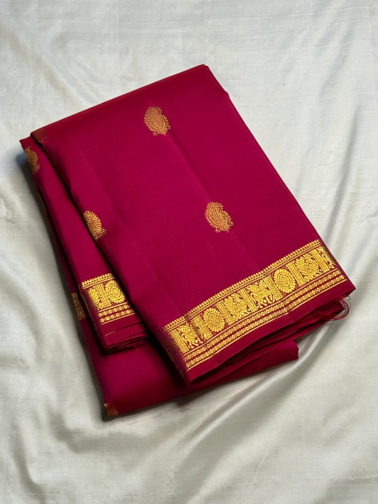 Close view of antique-gold zari buttas woven on Raspberry Pink Kanjivaram silk.
